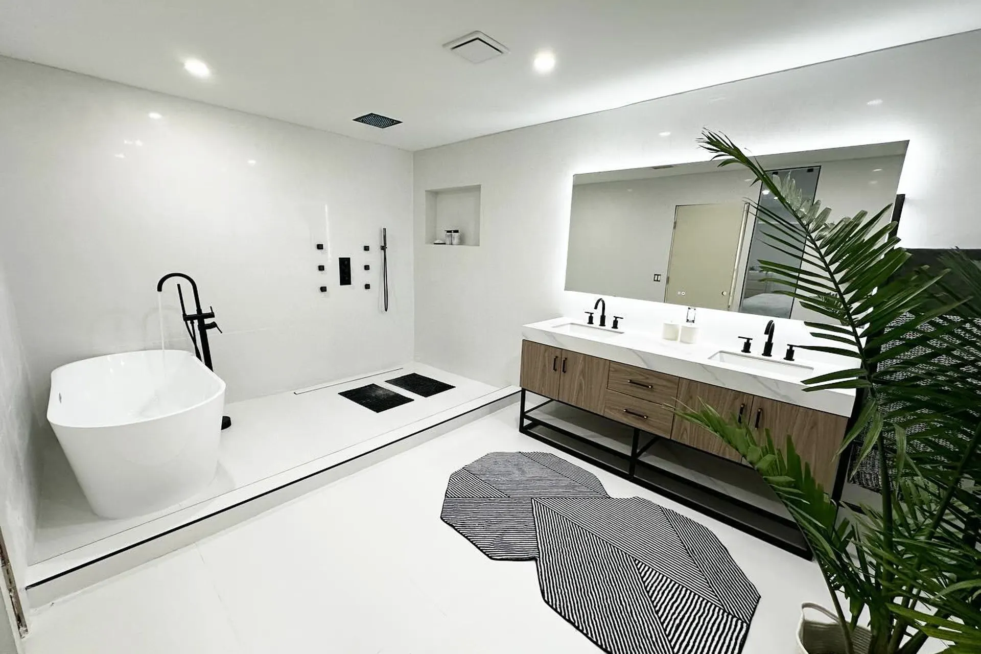 Remodeled primary bathroom with freestanding tub and double vanity